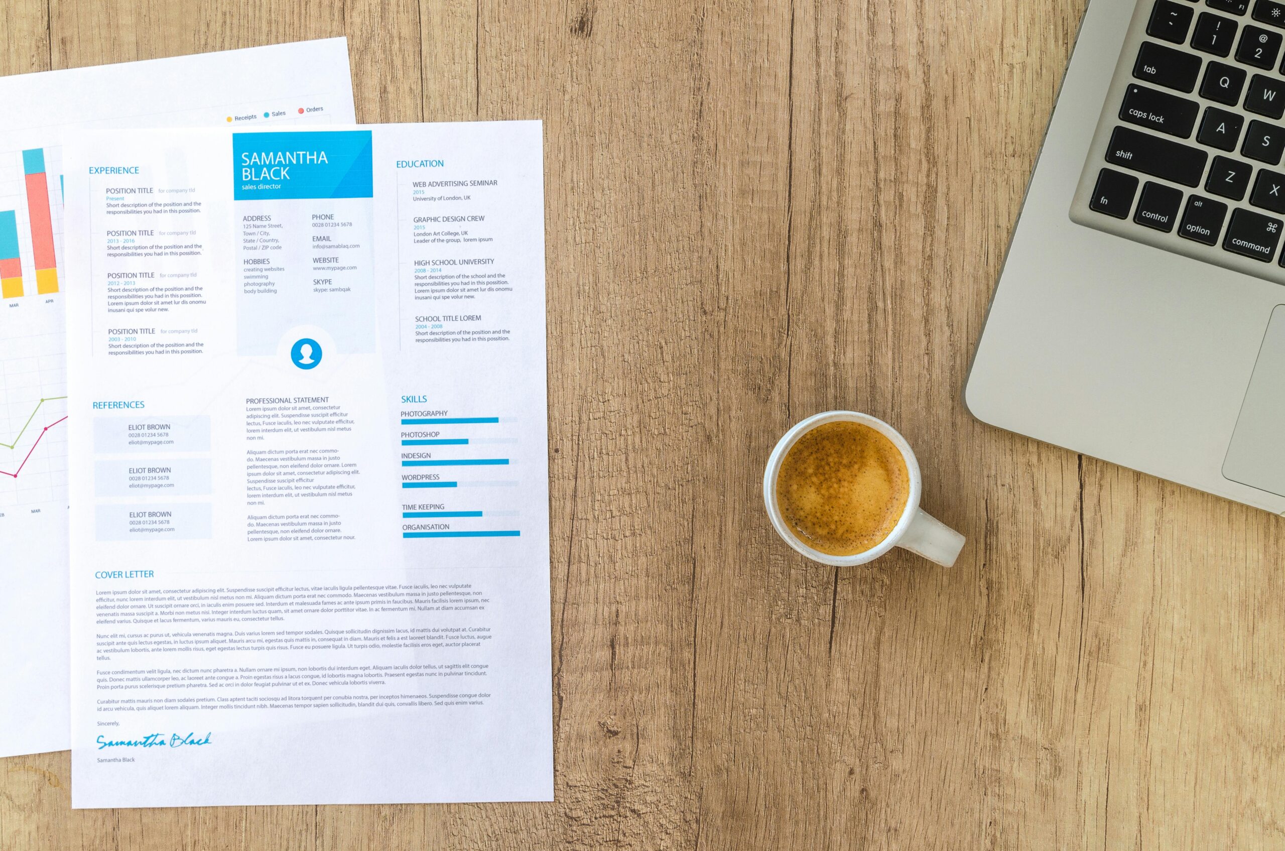 Desk with resume, coffee, and laptop on wood. Perfect for business concepts.